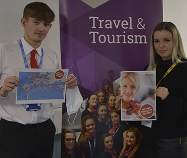 Travel & Tourism students holding up pages from their Jet2 welcome pack